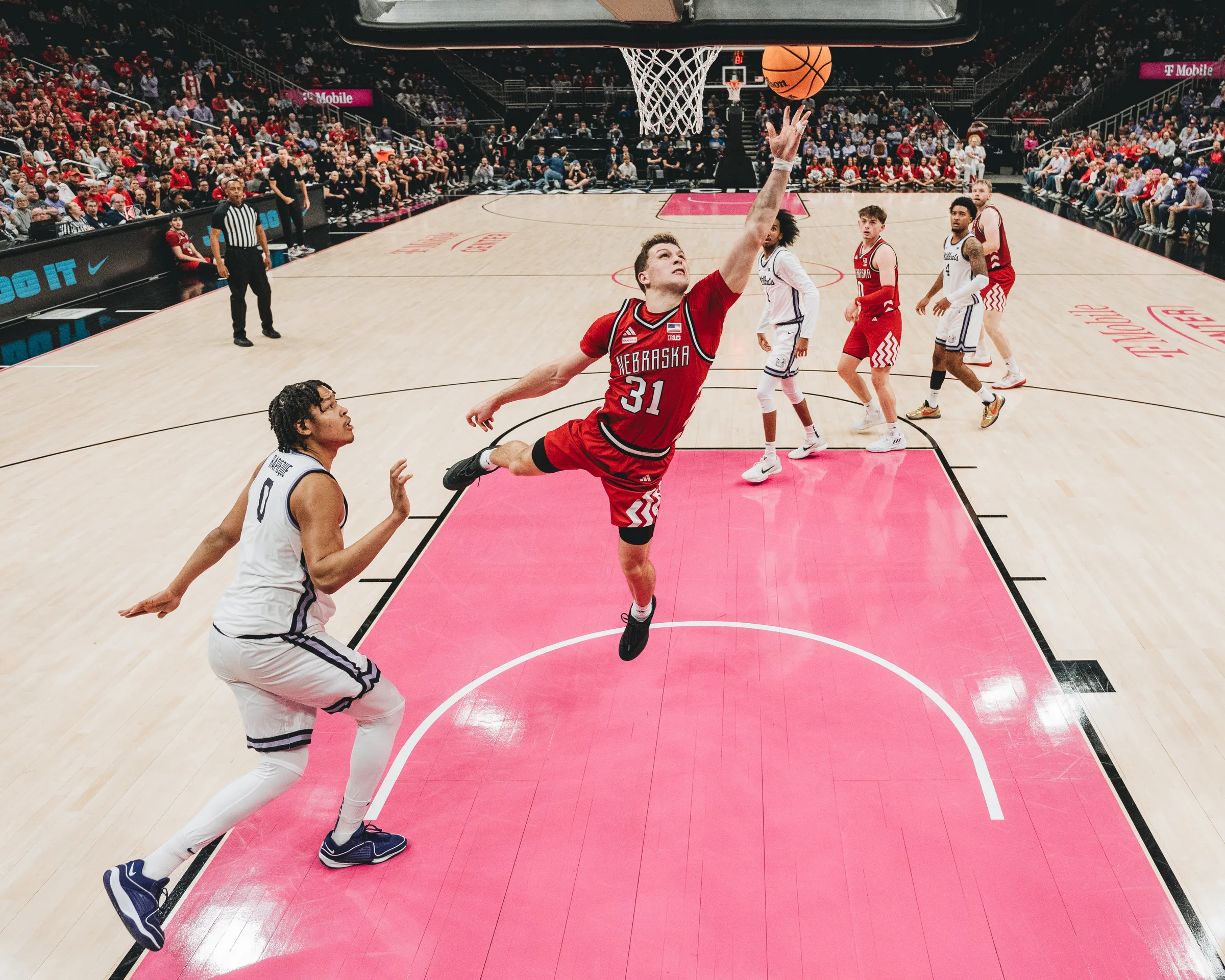 Nebraska Cornhuskers junior guard Cale Jacobsen (31) drives to the basket past a Kansas State Wildcats defender during the Hall of Fame Classic championship game at T-Mobile Center in Kansas City, Mo. Sam Hoiberg's free throw with 0.6 seconds remaining lifted Nebraska to an 86-85 win over Kansas State on Nov. 21, 2025, giving the Cornhuskers the Hall of Fame Classic title for the first time in program history.