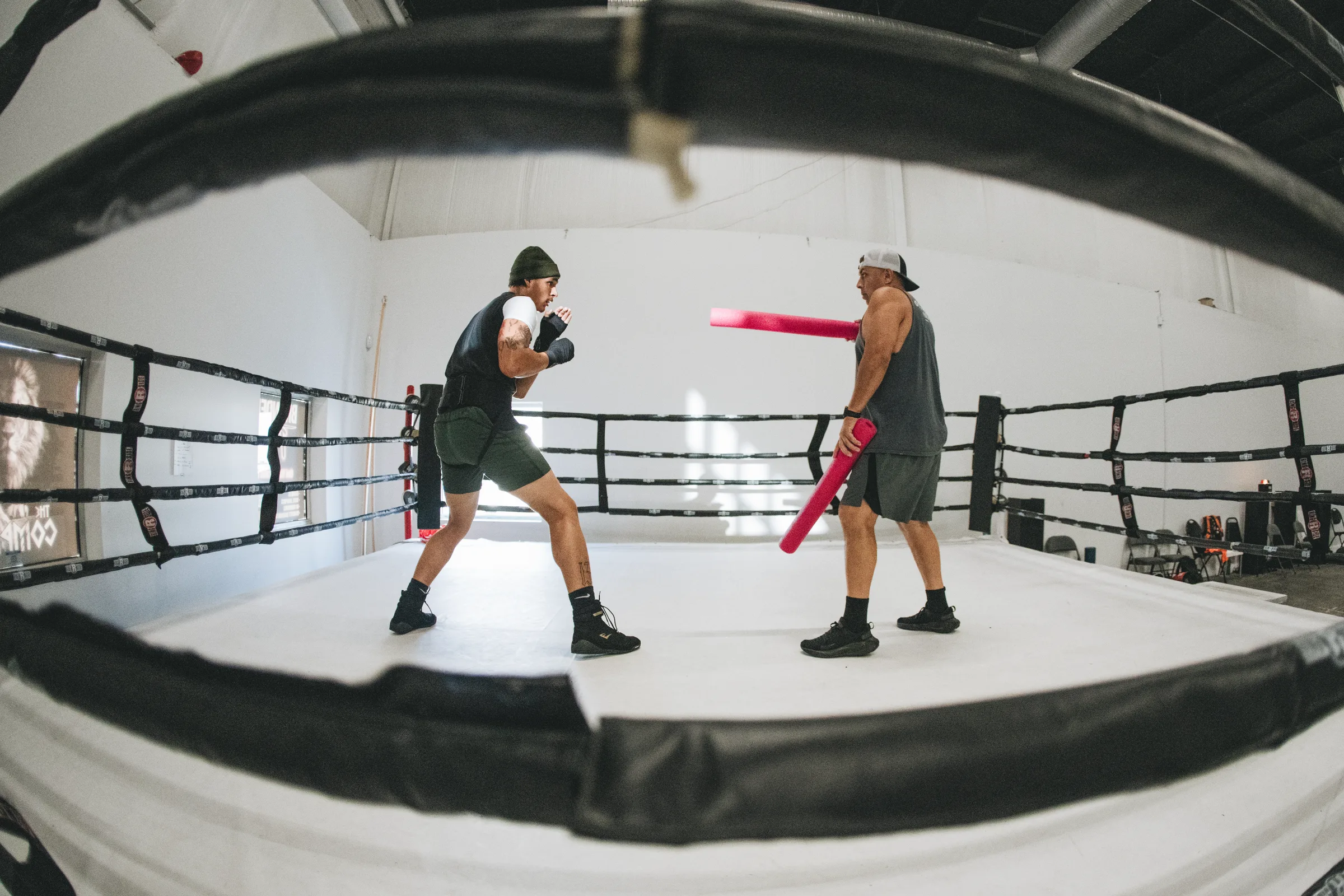 Nebraska boxer Jareese works on pad drills with his trainer inside the ring at a boxing gym as