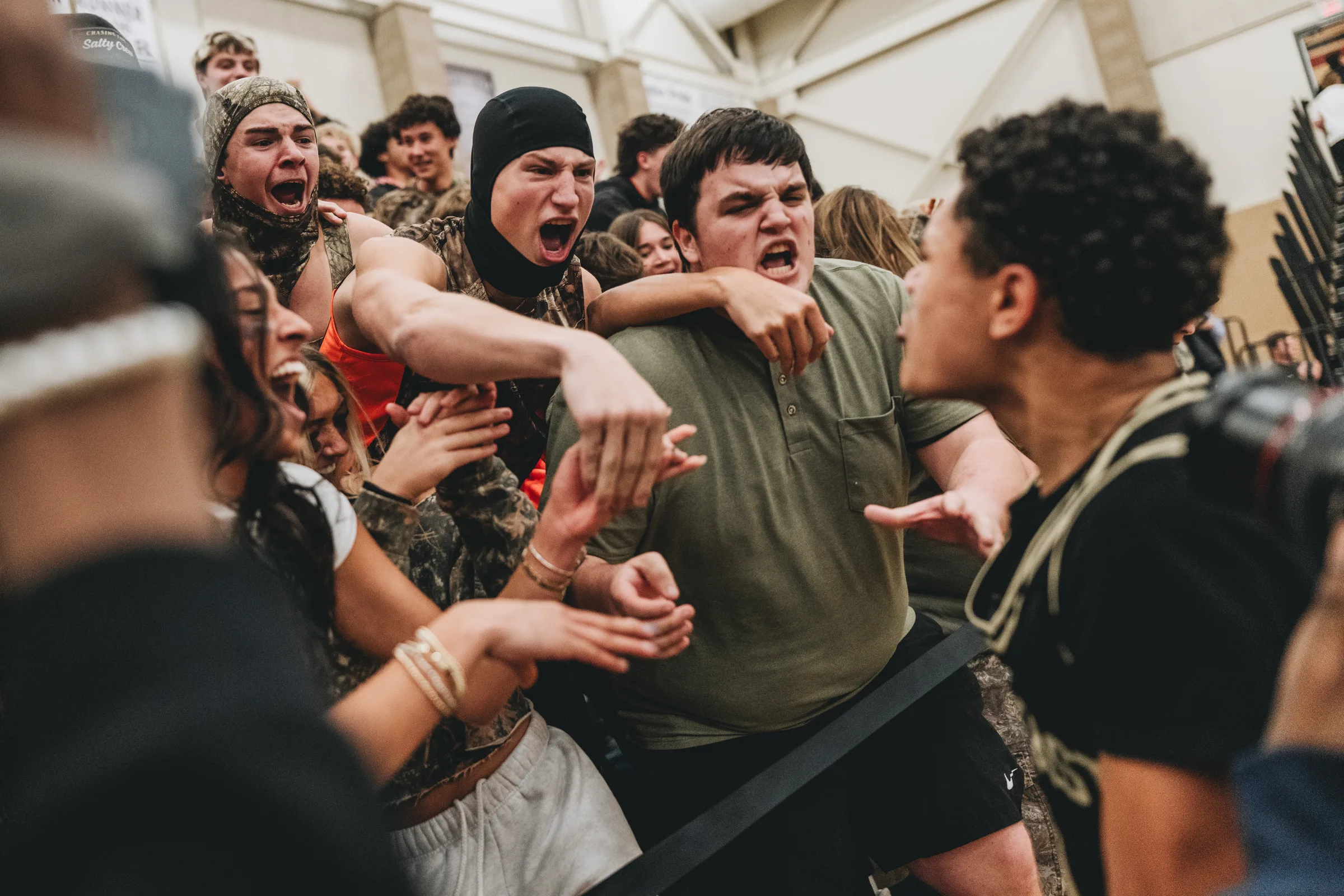 A Lincoln Southeast player shouts into the visiting student section as fans surge toward him during a boys varsity basketball game against the Lincoln East Spartans at Lincoln Southwest High School in Lincoln, Nebraska. The Silver Hawks defeated the Spartans, 62-56, in a non-conference home opener on Friday, Dec. 5, 2025.