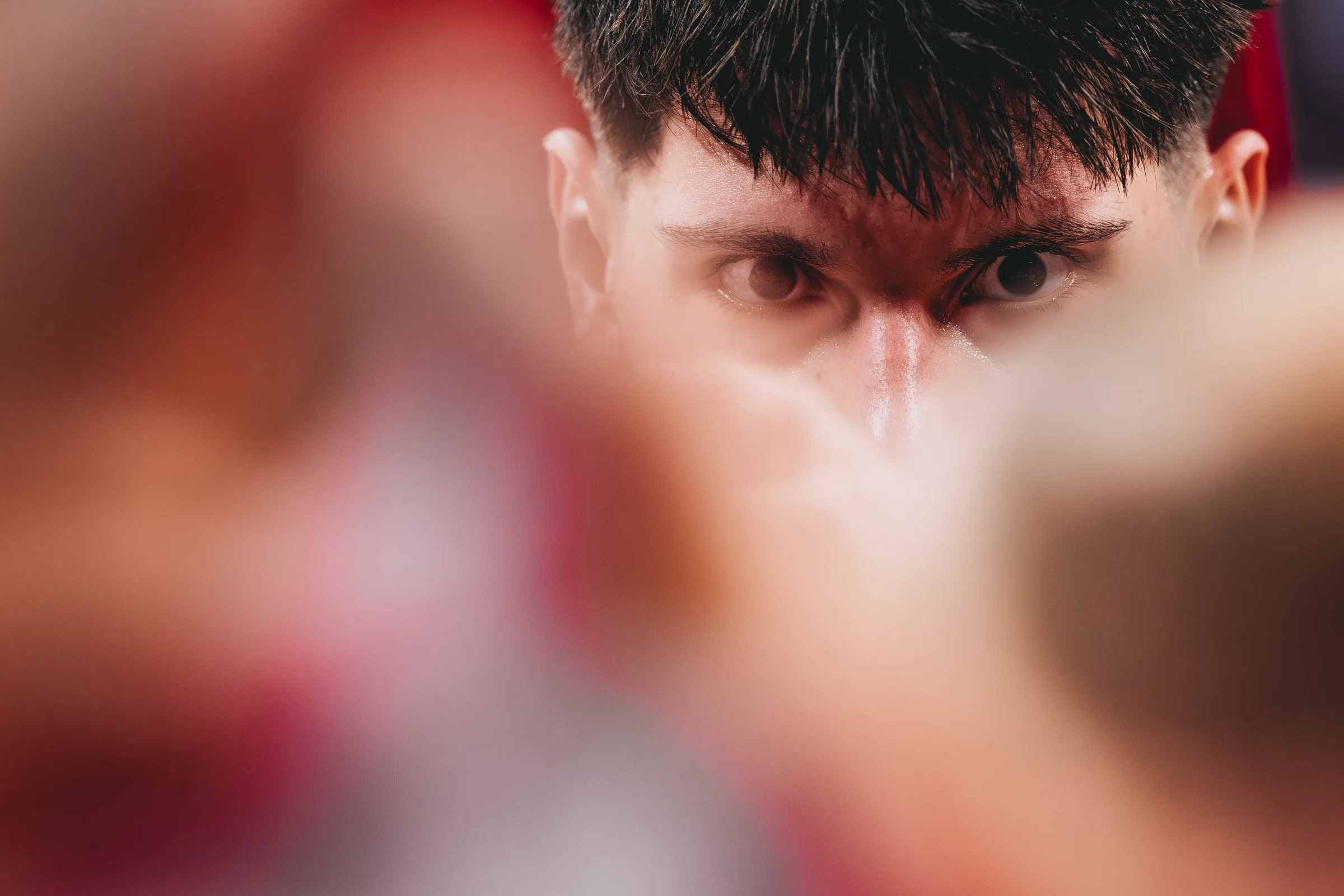 Nebraska forward Berke Buyuktuncel stares intensely through a huddle during a timeout against BYU at Pinnacle Bank Arena in Lincoln, Neb. The Cornhuskers hosted the No. 8 Cougars on Oct. 18, 2025, in a preseason exhibition game that Nebraska won 90-89.