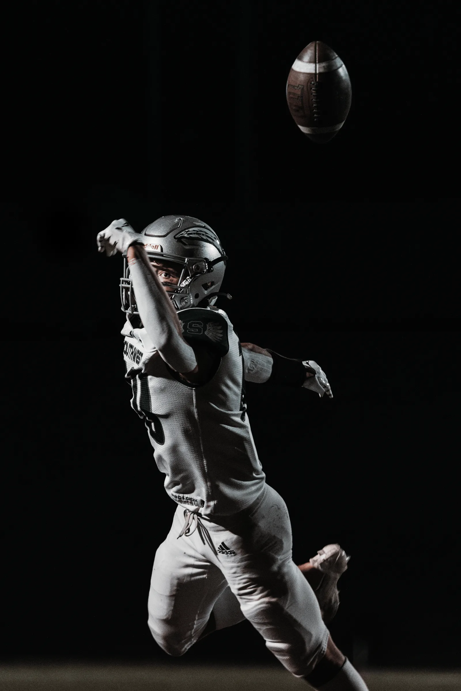 A Lincoln Southwest Silver Hawks receiver reaches for a pass that sails just beyond his reach.