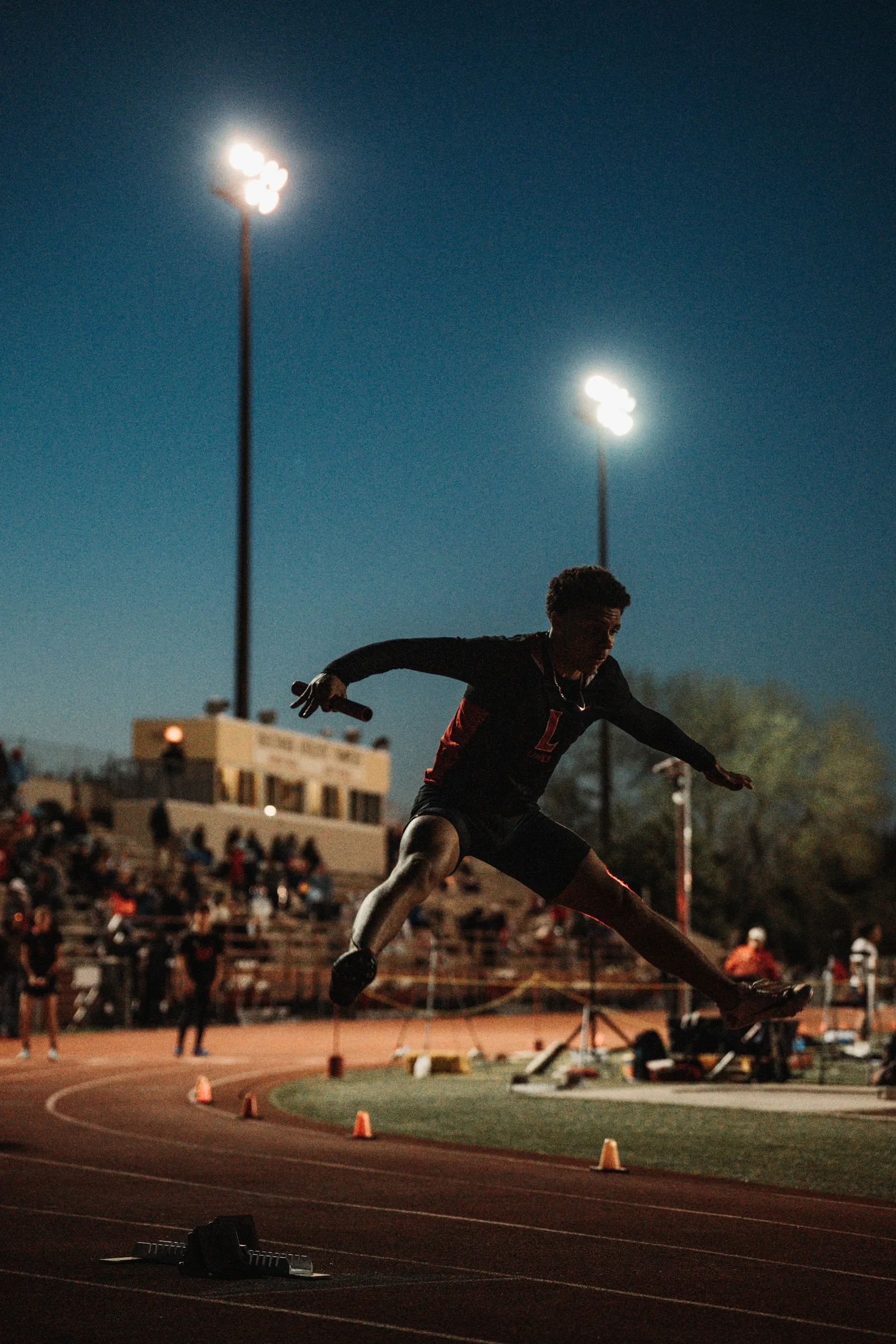 Lincoln High sprinter Zion Jenkins explodes out of the blocks during warmups for the 4x400-meter relay at the school's outdoor track in Lincoln, Neb.