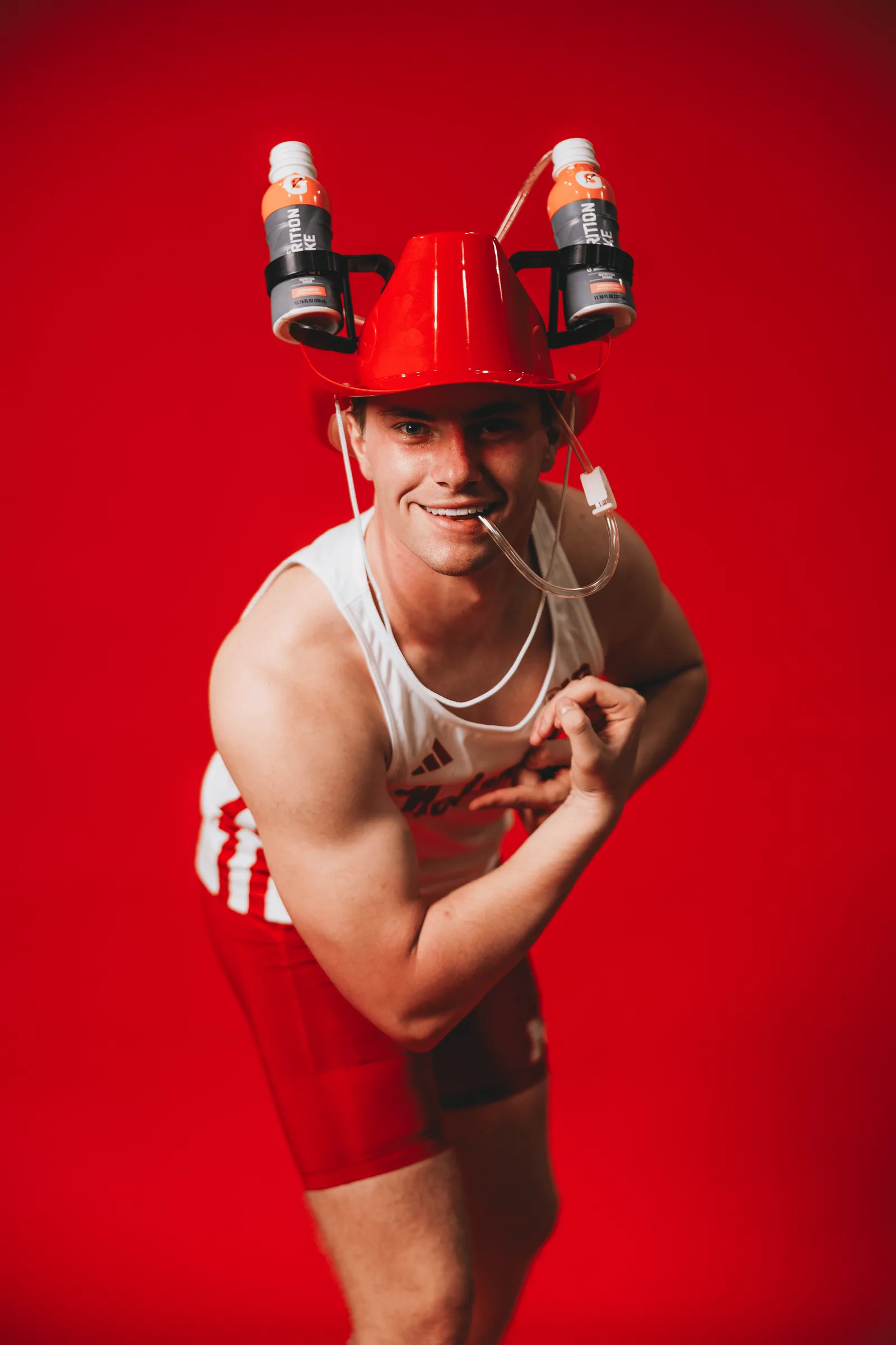 A Nebraska field athlete poses with a Gatorade drinking helmet during media day.