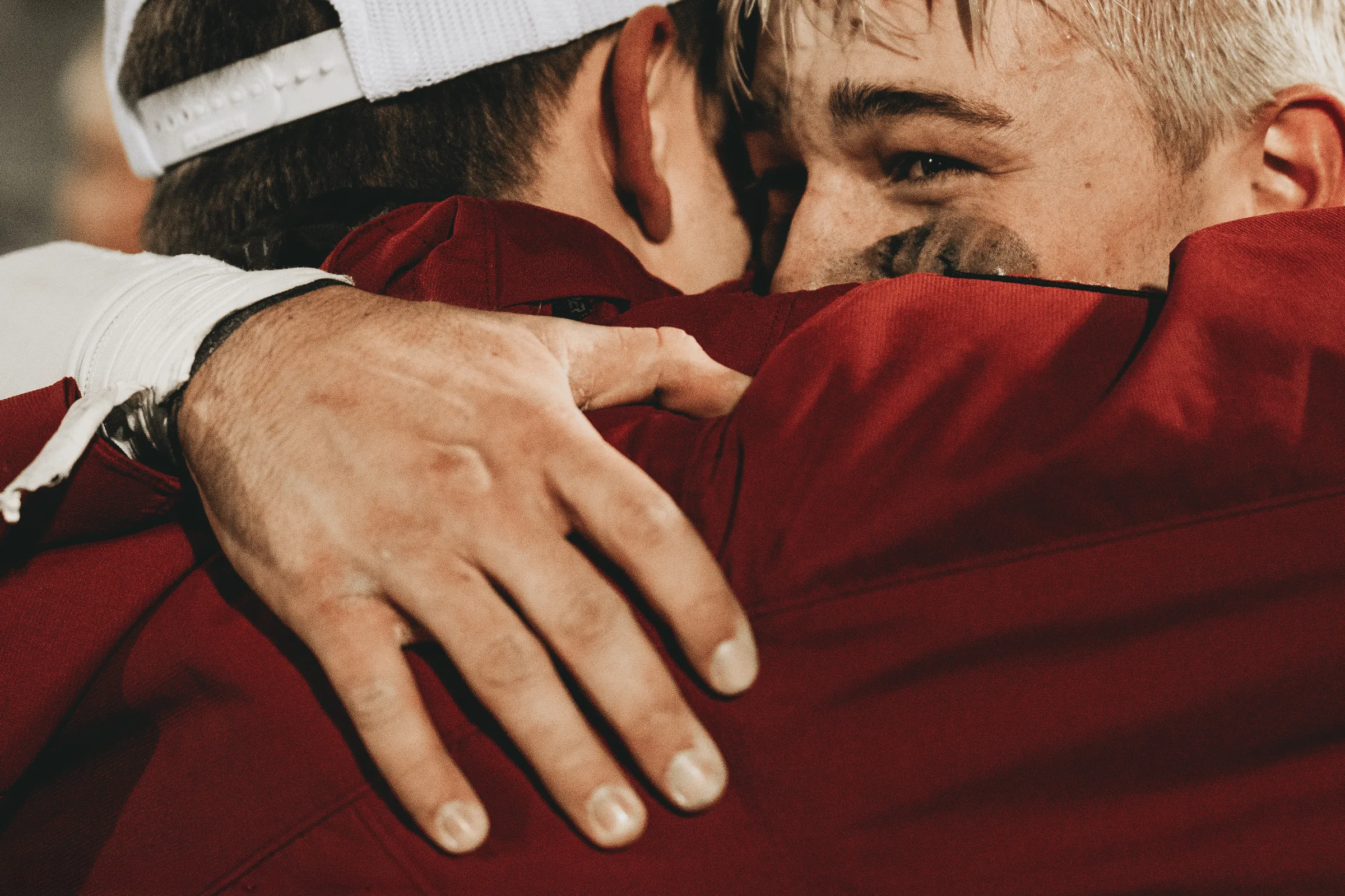 A Stuart Broncos player embraces head coach Colin Schurman after winning the NSAA Class D-6 six-man football championship game.