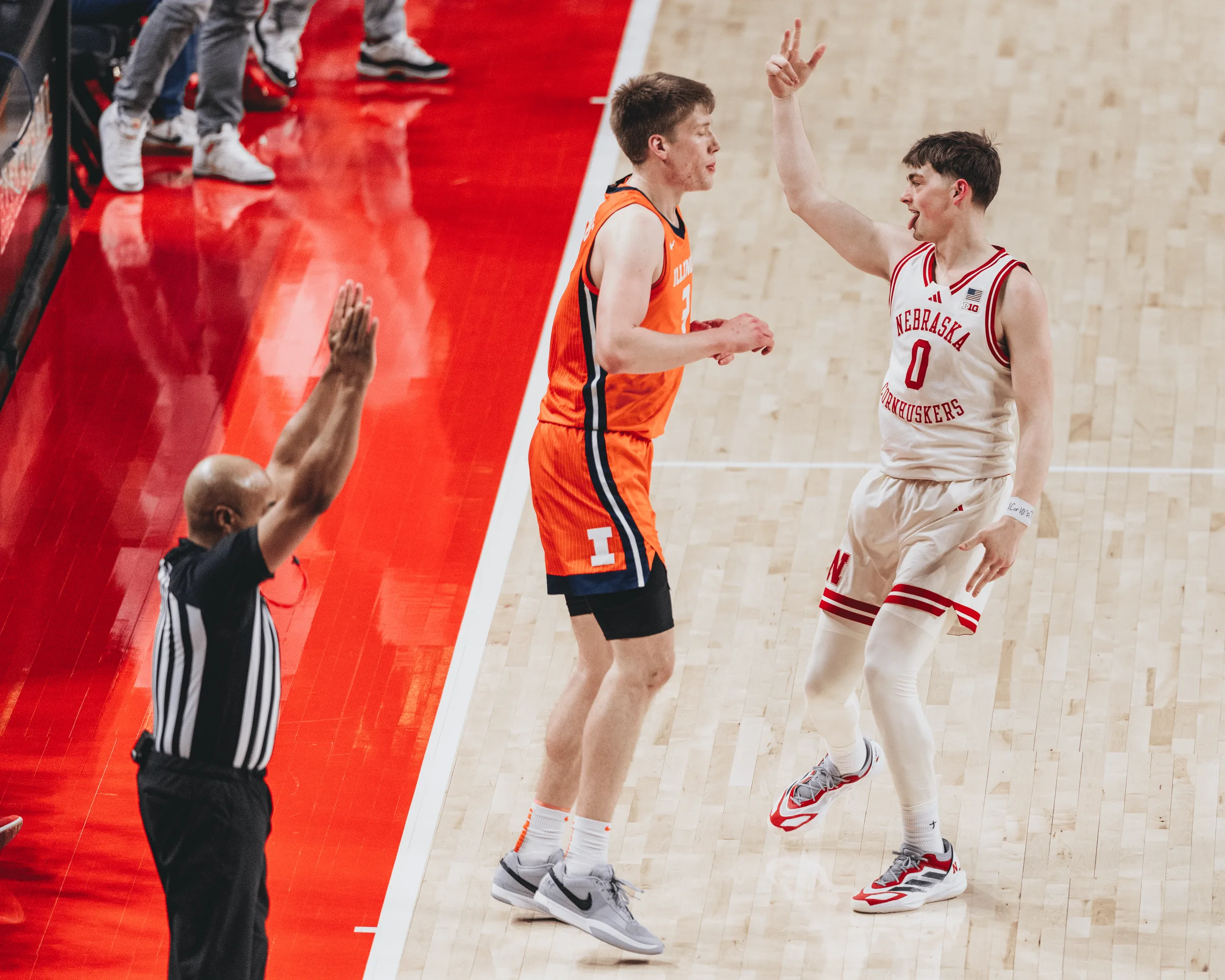 Nebraska guard Connor Essegian (0) celebrates after hitting a three-pointer in front of an Illinois defender during the Cornhuskers' 80-74 overtime victory at Pinnacle Bank Arena in Lincoln, Neb. The win on Jan. 30, 2025, snapped a six-game losing streak for the Huskers and handed No. 18 Illinois its fifth conference loss of the season.